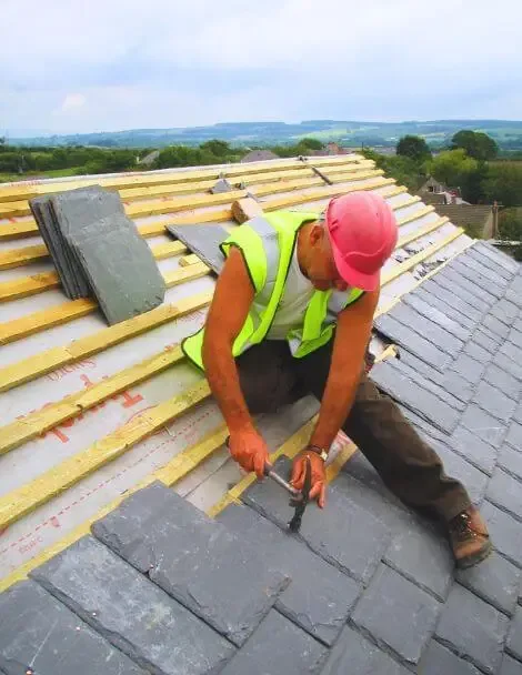 Roofer performing complete roof replacement tear-off in El Cajon